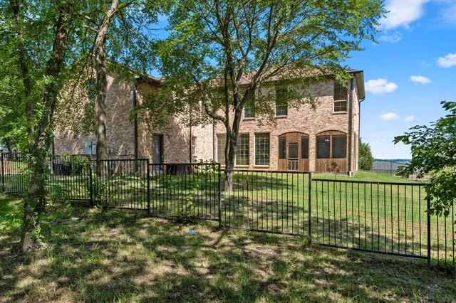 a front view of a house with a garden and plants