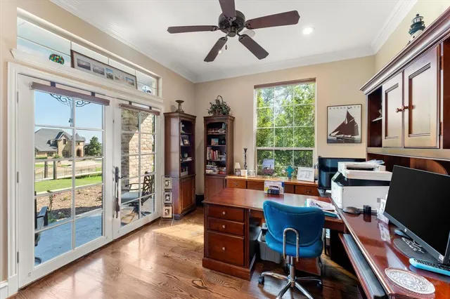 a view of a workspace with furniture and a window