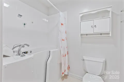 a bedroom with a bed and a potted plant