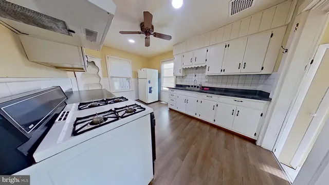 a kitchen with stainless steel appliances a stove a sink and a refrigerator