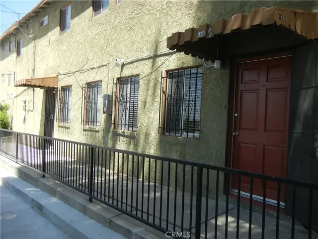 a view of a house with a wooden fence