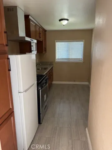 a kitchen with stainless steel appliances a refrigerator and a stove