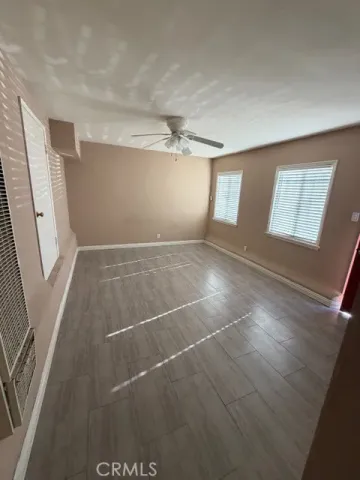 an empty room with windows and entrance