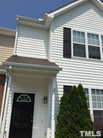 a front view of a house with plants