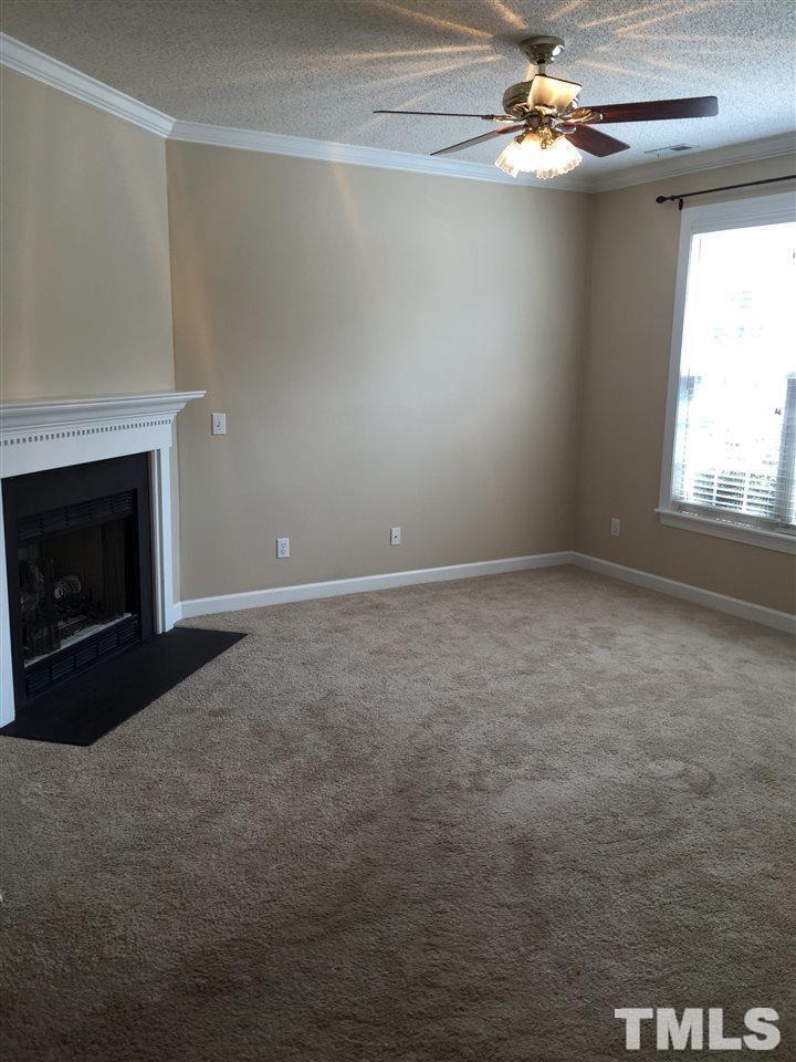 8605 London Park Court Raleigh, NC 27615 - Photo 5 of 18 a view of empty room with window and fireplace