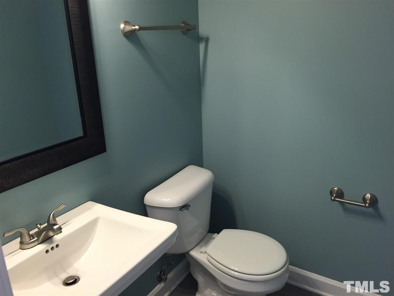 8605 London Park Court Raleigh, NC 27615 - Photo 9 of 18 a white toilet sitting next to a bathroom sink