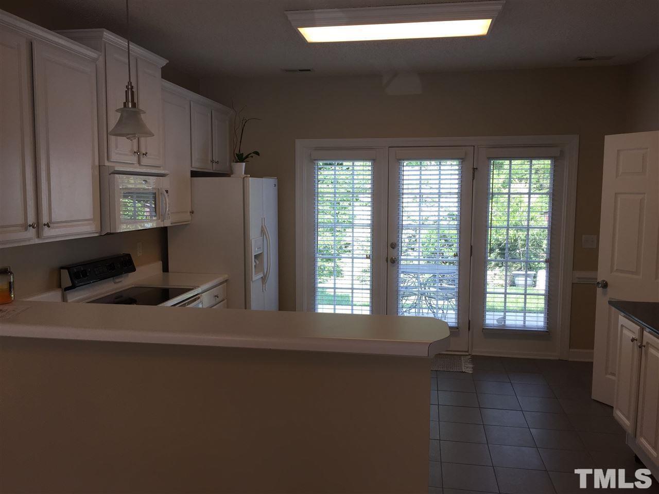 8605 London Park Court Raleigh, NC 27615 - Photo 10 of 18 a view of a kitchen with a sink dishwasher and a refrigerator