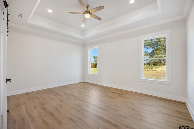 a spacious bathroom with a double vanity sink a mirror and a bathtub