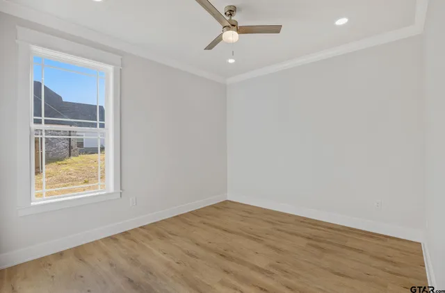a view of a room with wooden floor and white walls