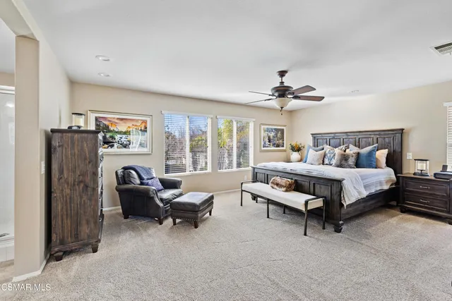 a bedroom with furniture and a large window