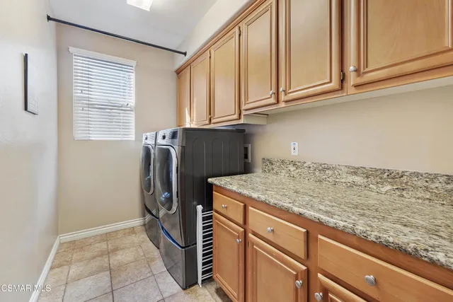 a kitchen with stainless steel appliances granite countertop a refrigerator and a cabinets