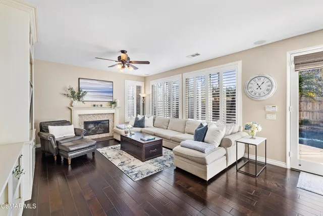a living room with furniture a fireplace and a window