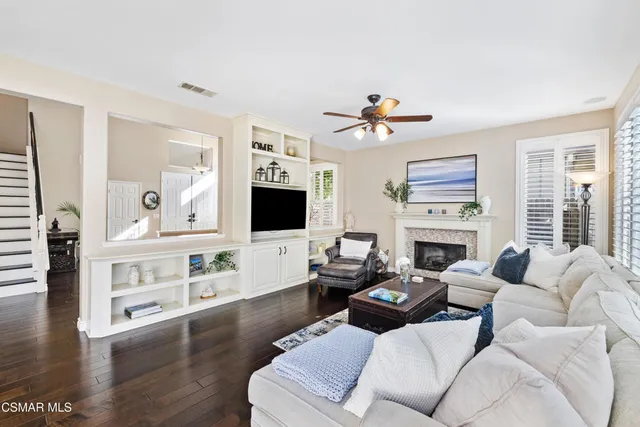 a living room with furniture fireplace and a flat screen tv