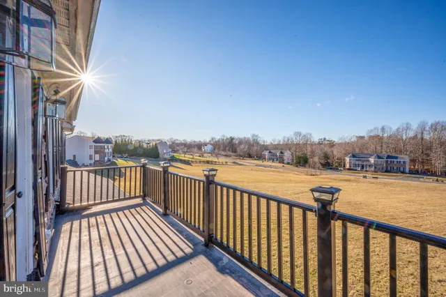 a living room with furniture potted plant and a large window