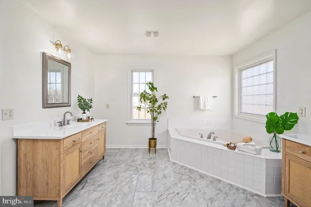 a living room with furniture potted plant and wooden floor