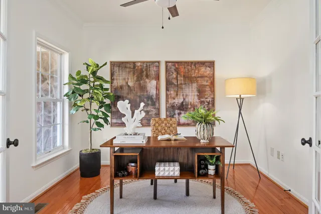 a view of a hallway with wooden floor and staircase