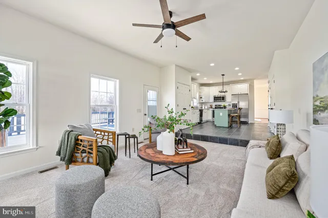 a view of a livingroom with a ceiling fan and window