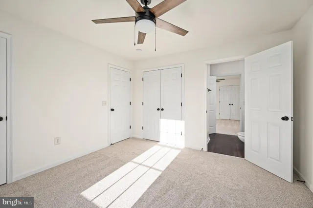 a view of a large house with a big yard and large trees