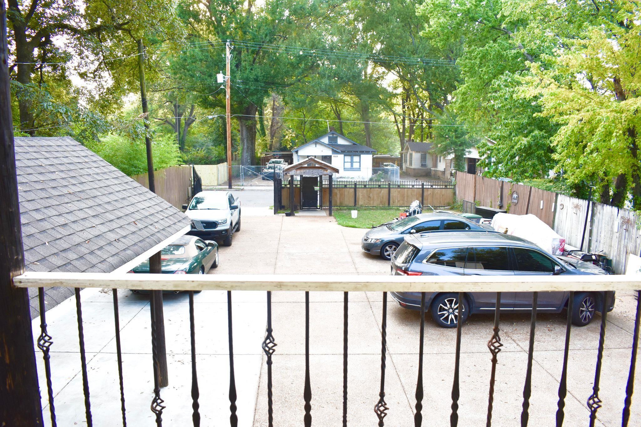 712 Sevier Street Memphis, TN 38122 - Photo 11 of 13 a view of a patio with table and chairs and couches with wooden fence and floor