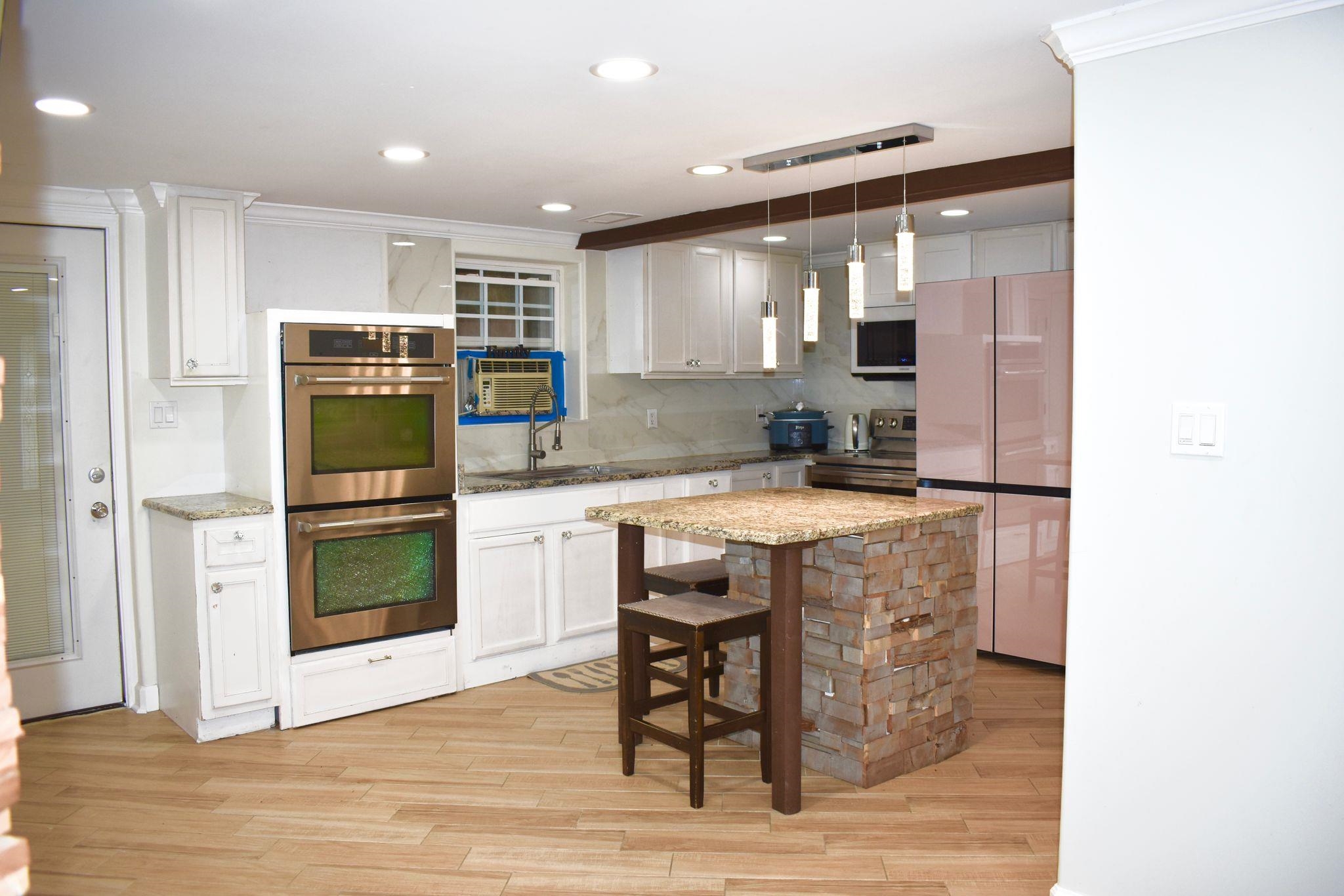 712 Sevier Street Memphis, TN 38122 - Photo 8 of 13 a kitchen with stainless steel appliances granite countertop a stove and a refrigerator
