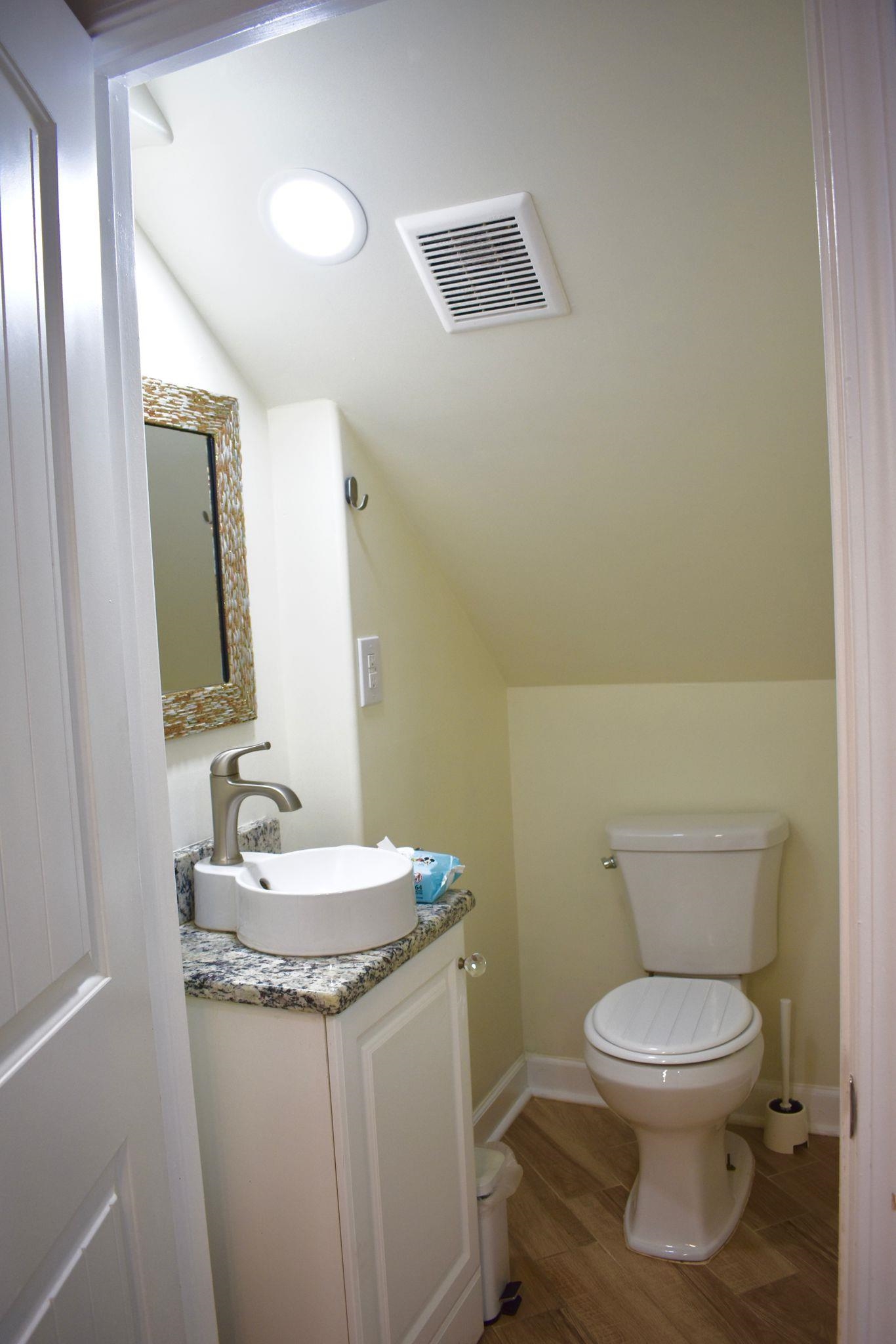712 Sevier Street Memphis, TN 38122 - Photo 9 of 13 a bathroom with a toilet a sink and a mirror