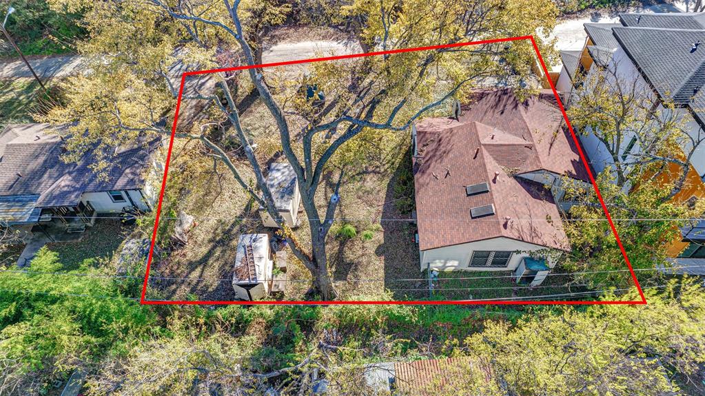 917 Walkway Street Dallas, TX 75212 - Photo 6 of 15 a view of a white house with large trees and flower plants