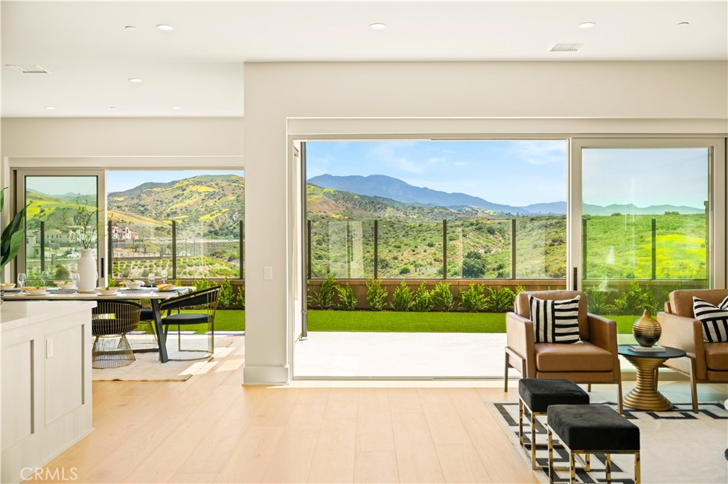 a view of a swimming pool and mountain from a living room