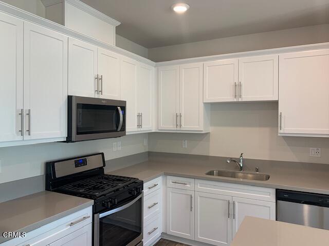 312 Dominguez Street Camarillo, CA 93010 - Photo 6 of 25 a kitchen with cabinets appliances a sink and a counter top
