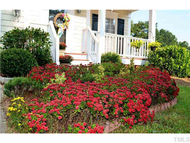 7617 Overland Trail Raleigh, NC 27615 - Photo 11 of 25 a view of a and house with flower garden