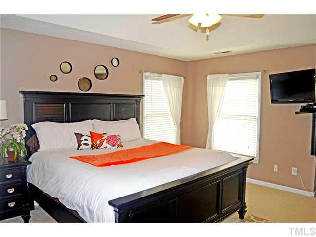 7617 Overland Trail Raleigh, NC 27615 - Photo 22 of 25 a bedroom with a bed and a flat screen tv