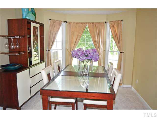 7617 Overland Trail Raleigh, NC 27615 - Photo 9 of 25 a view of a dining room with furniture and window