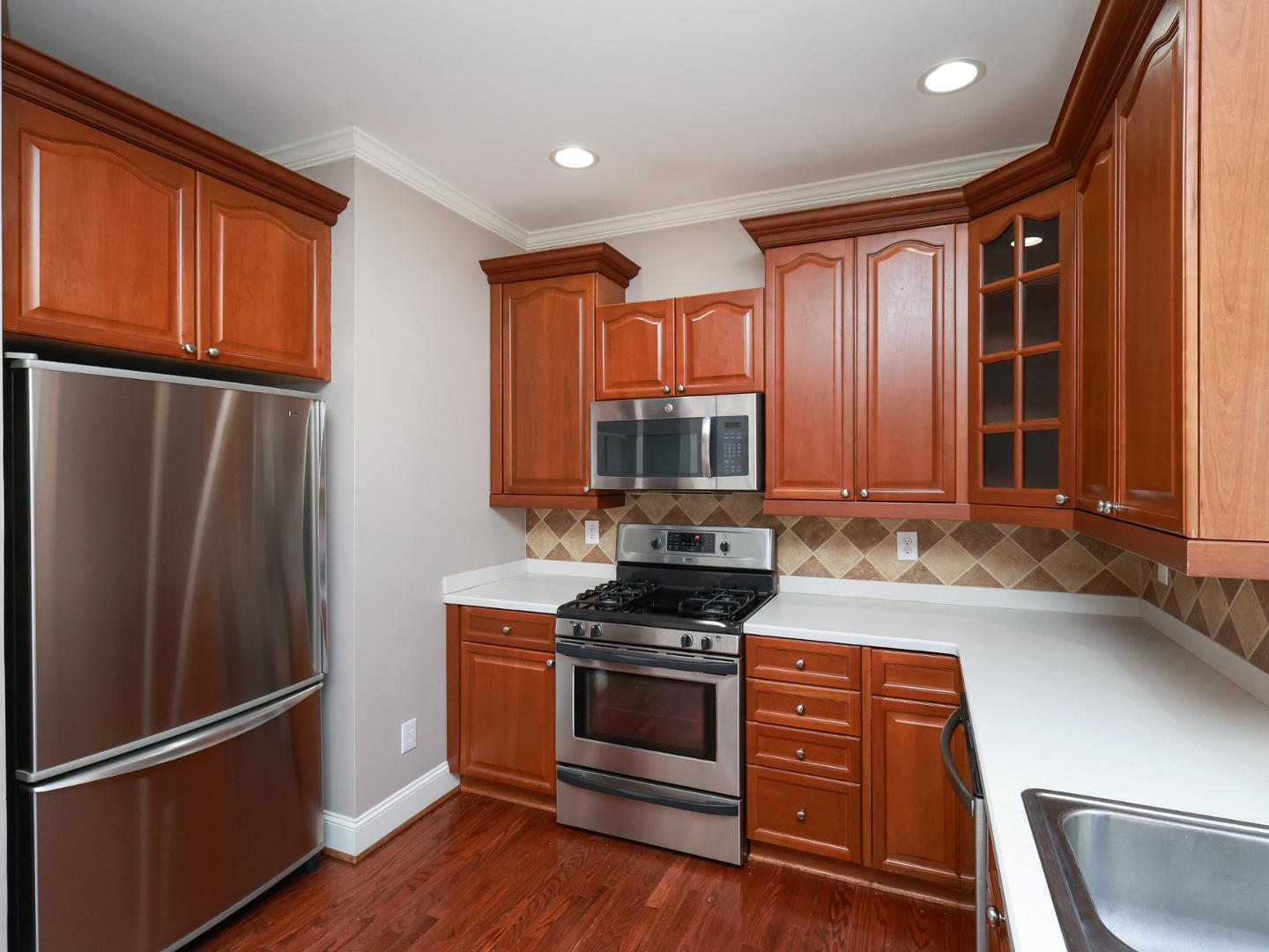 1155 Harp Street Raleigh, NC 27604 - Photo 11 of 33 a kitchen with stainless steel appliances granite countertop a refrigerator stove and sink