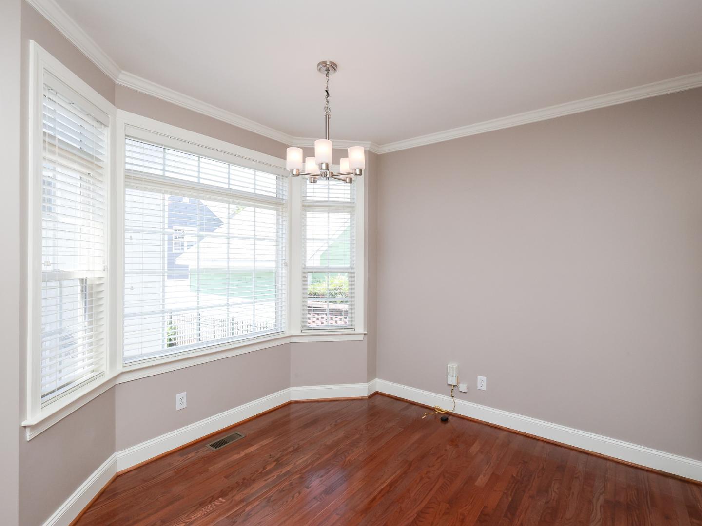 1155 Harp Street Raleigh, NC 27604 - Photo 14 of 33 a view of an empty room with wooden floor and a window