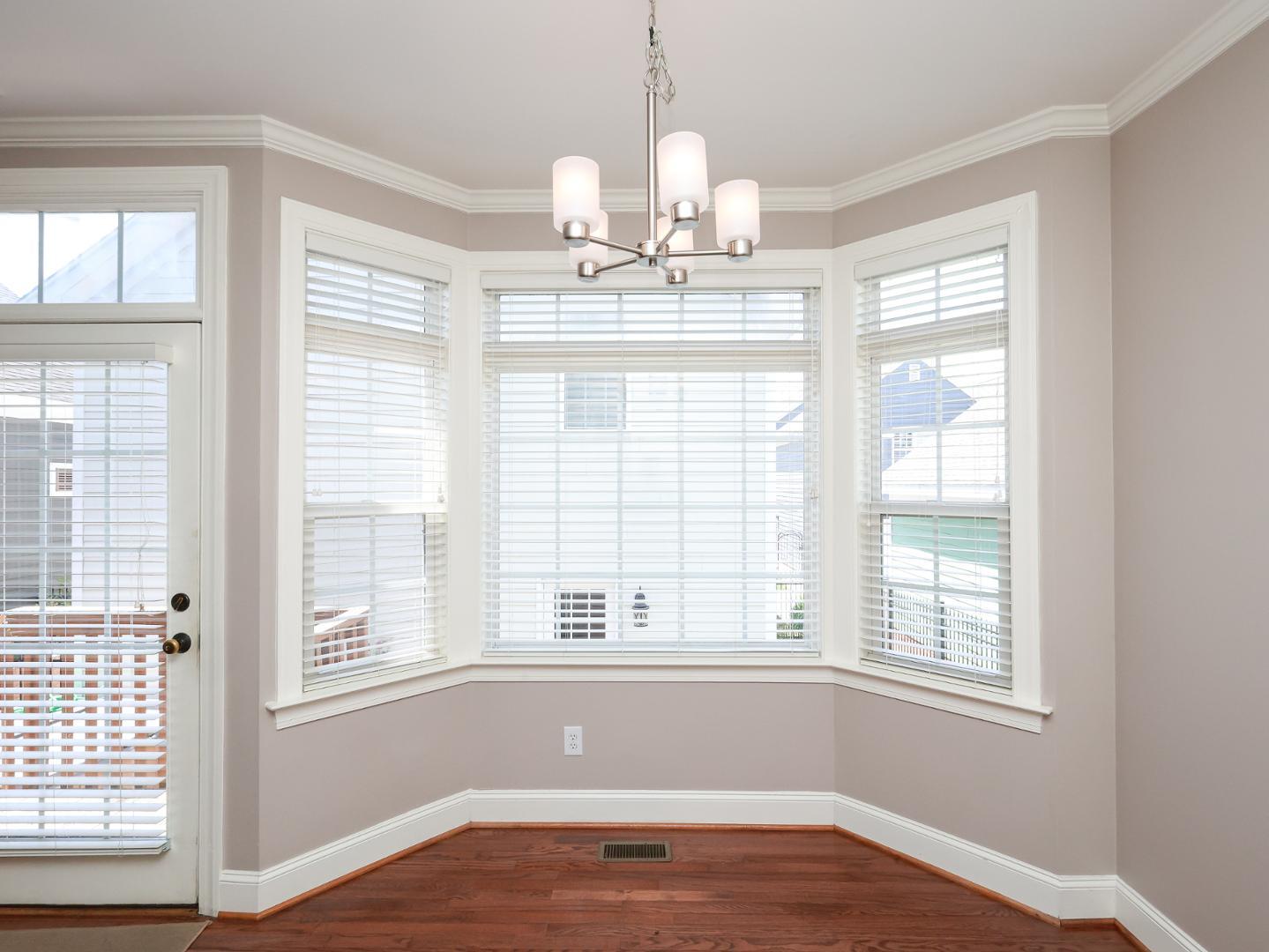 1155 Harp Street Raleigh, NC 27604 - Photo 15 of 33 a view of an empty room with wooden floor and a window