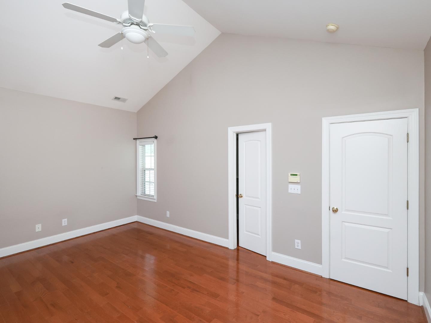 1155 Harp Street Raleigh, NC 27604 - Photo 19 of 33 an empty room with wooden floor closet and windows fan