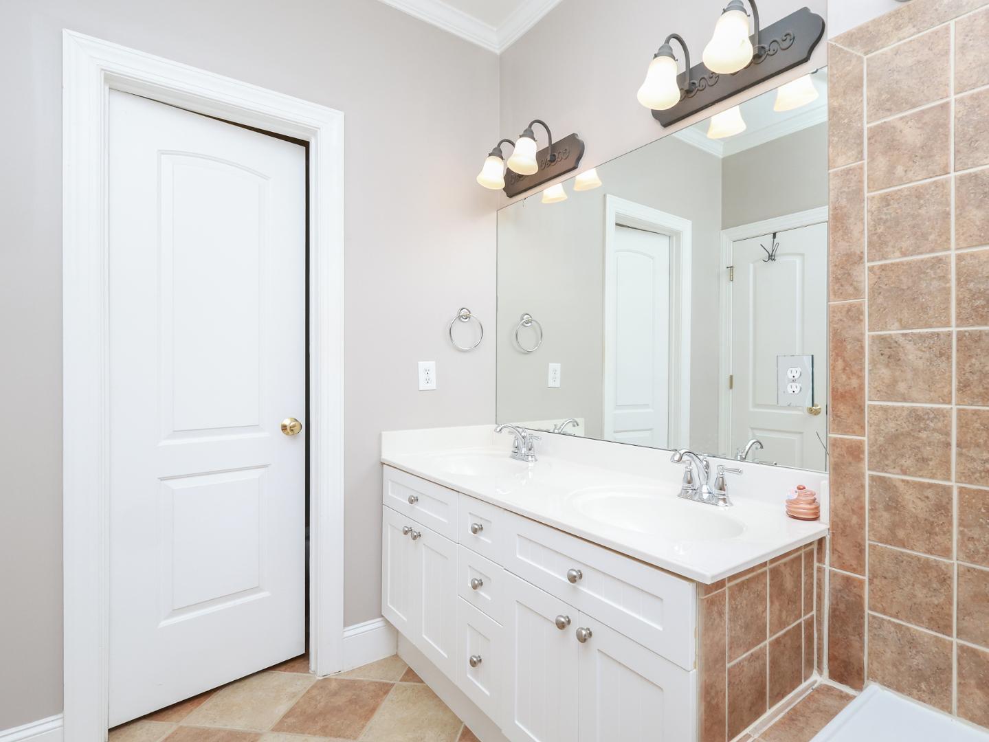 1155 Harp Street Raleigh, NC 27604 - Photo 21 of 33 a bathroom with a sink a mirror and a shower