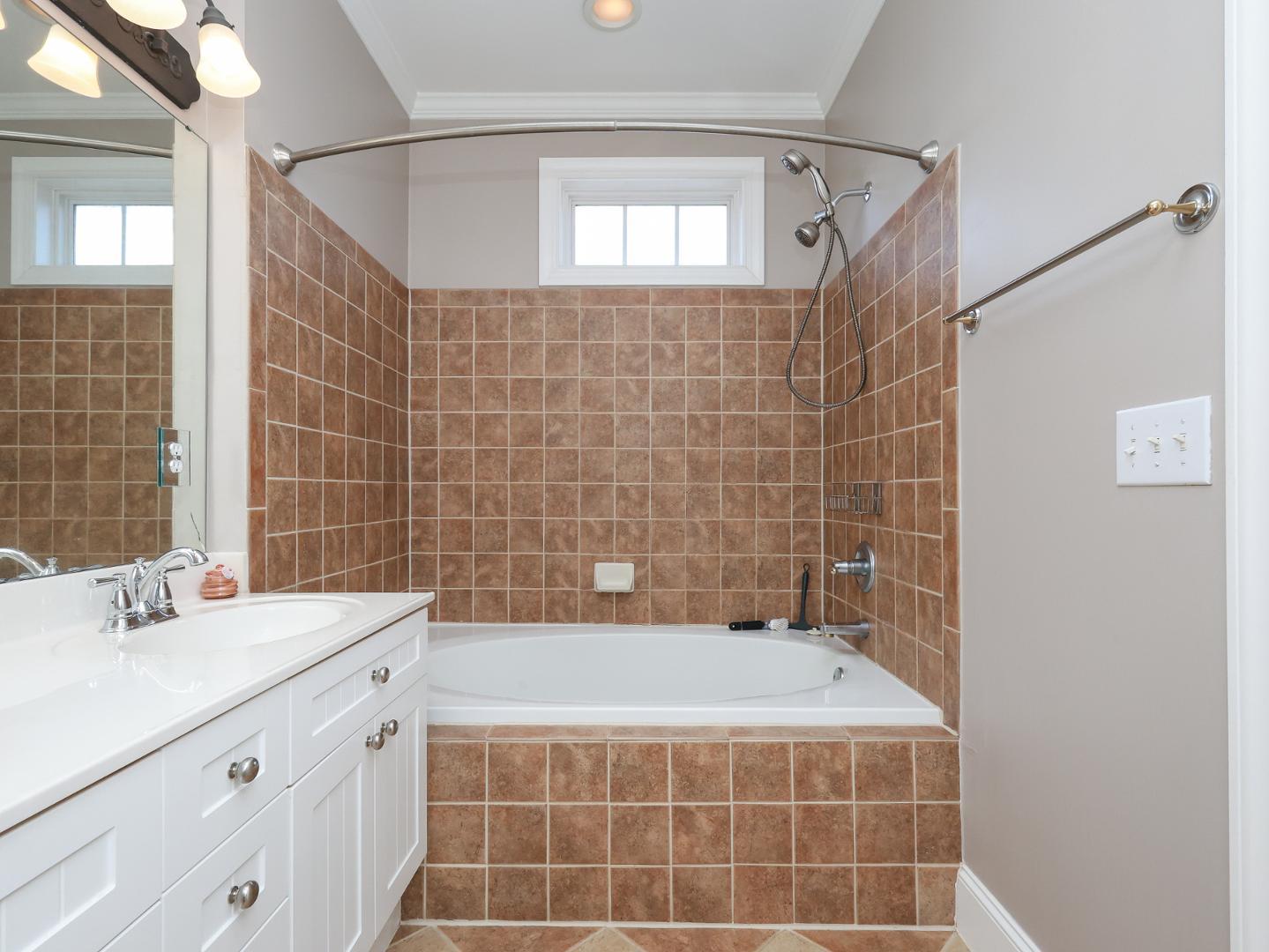1155 Harp Street Raleigh, NC 27604 - Photo 22 of 33 a bathroom with a sink mirror and a bathtub