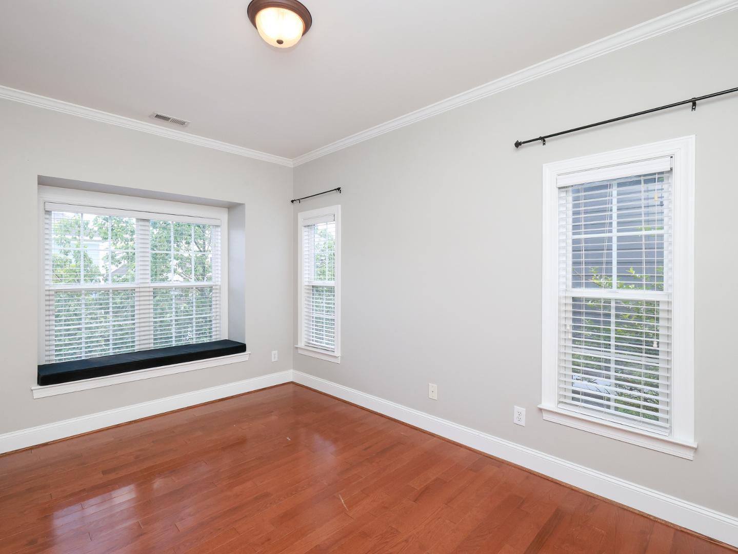 1155 Harp Street Raleigh, NC 27604 - Photo 23 of 33 a view of an empty room with wooden floor and a window