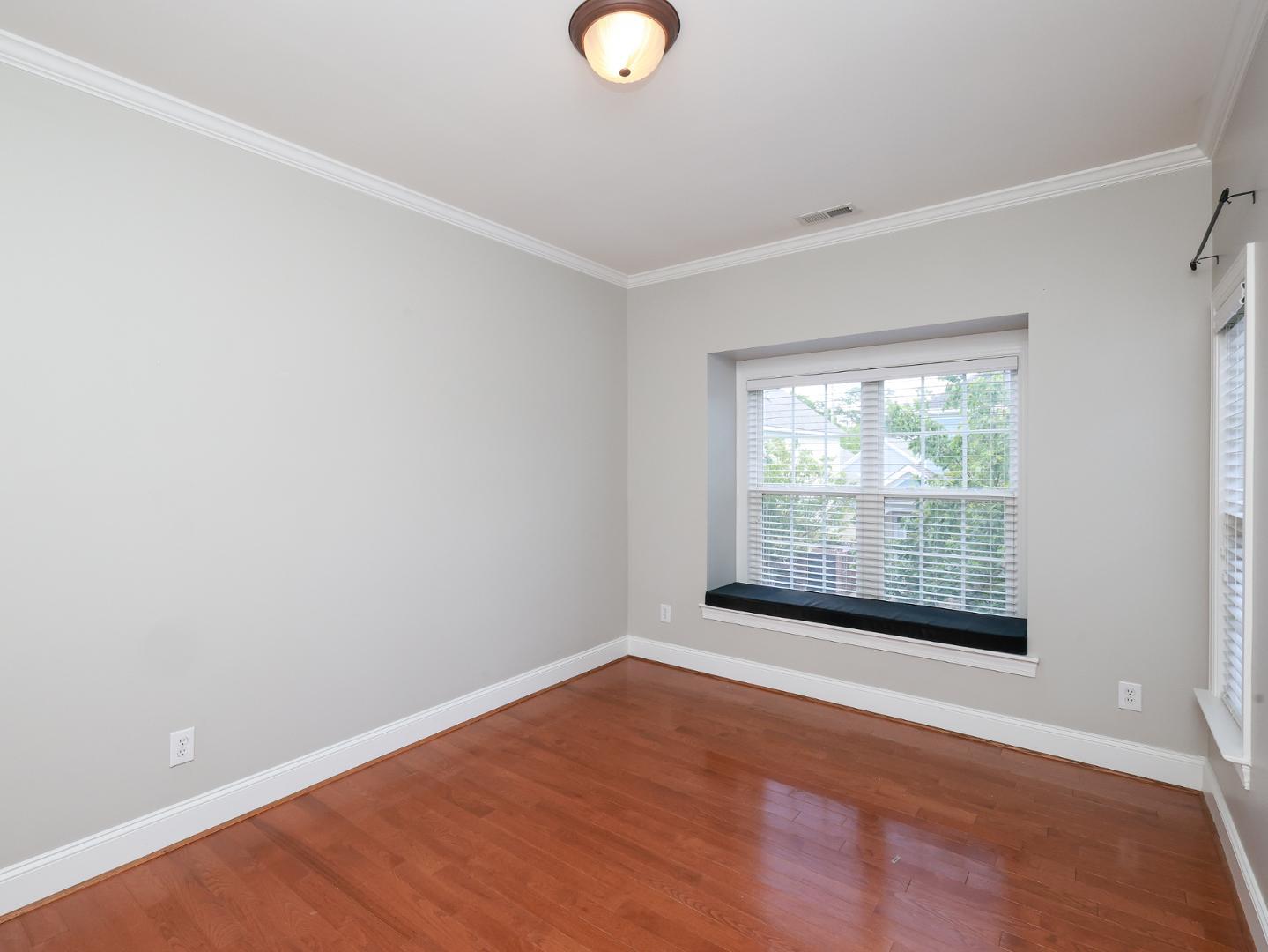 1155 Harp Street Raleigh, NC 27604 - Photo 24 of 33 a view of an empty room with wooden floor and a window