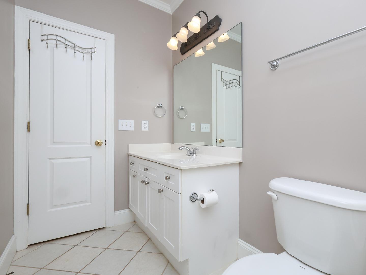 1155 Harp Street Raleigh, NC 27604 - Photo 28 of 33 a bathroom with a toilet sink and mirror
