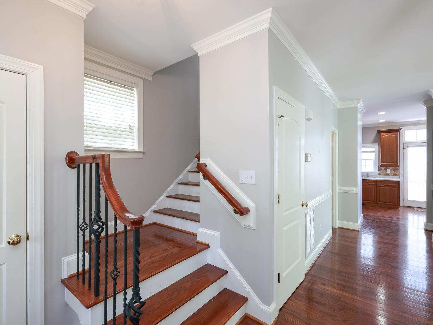 1155 Harp Street Raleigh, NC 27604 - Photo 3 of 33 a view of a hallway with wooden floor and staircase