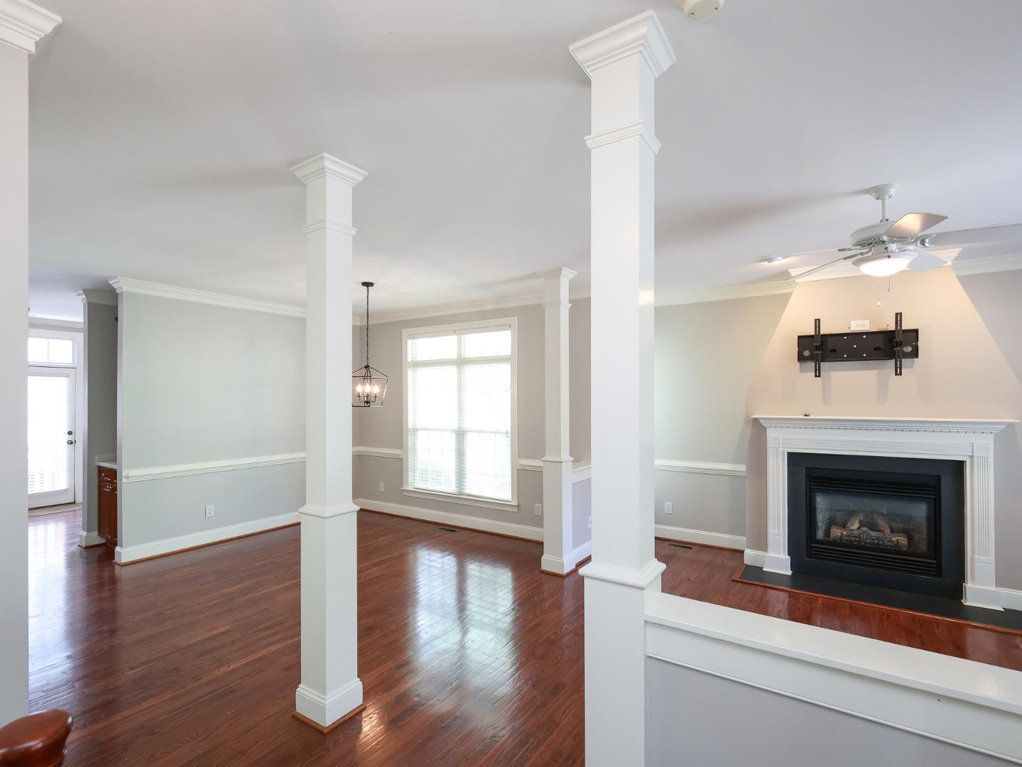1155 Harp Street Raleigh, NC 27604 - Photo 4 of 33 a living room with wooden floor and a fireplace