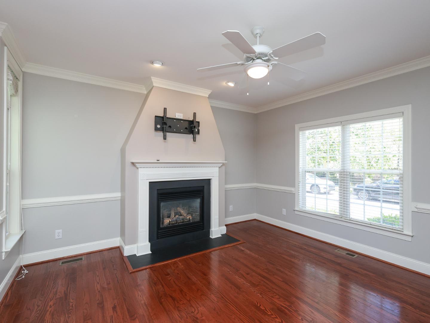 1155 Harp Street Raleigh, NC 27604 - Photo 5 of 33 a living room with a fireplace and wooden floor