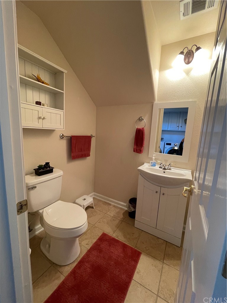 2832 Cottage Lane Paso Robles, CA 93446 - Photo 12 of 19 a bathroom with a toilet sink and mirror