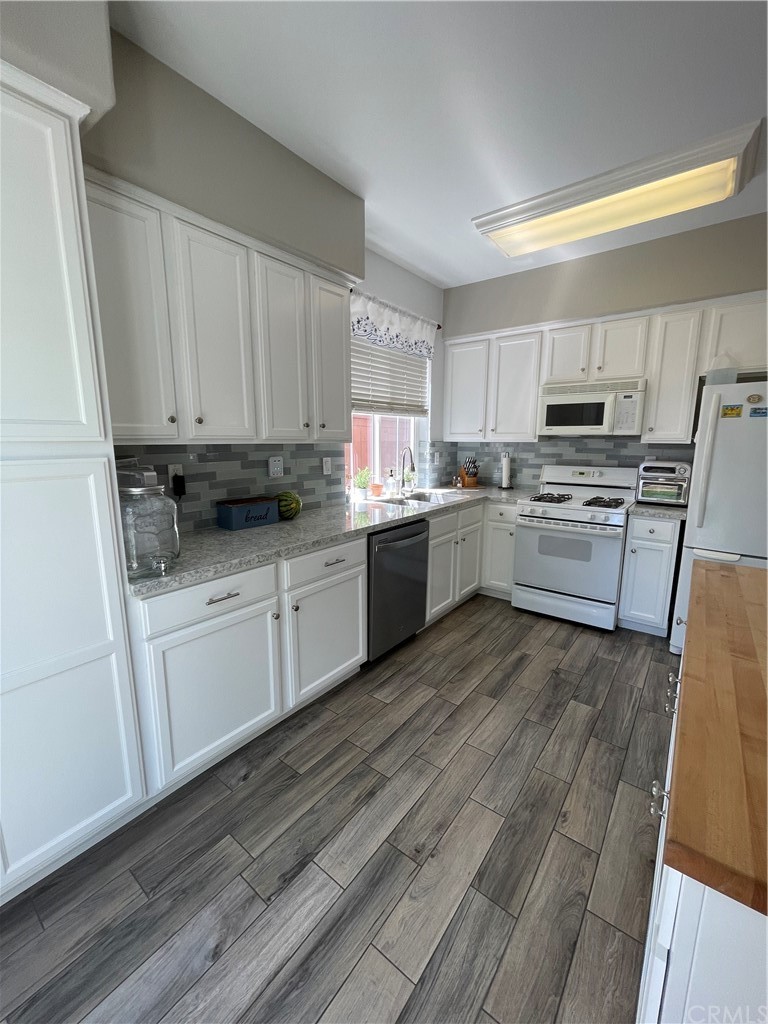 2832 Cottage Lane Paso Robles, CA 93446 - Photo 9 of 19 a kitchen with granite countertop a stove top oven sink and cabinets