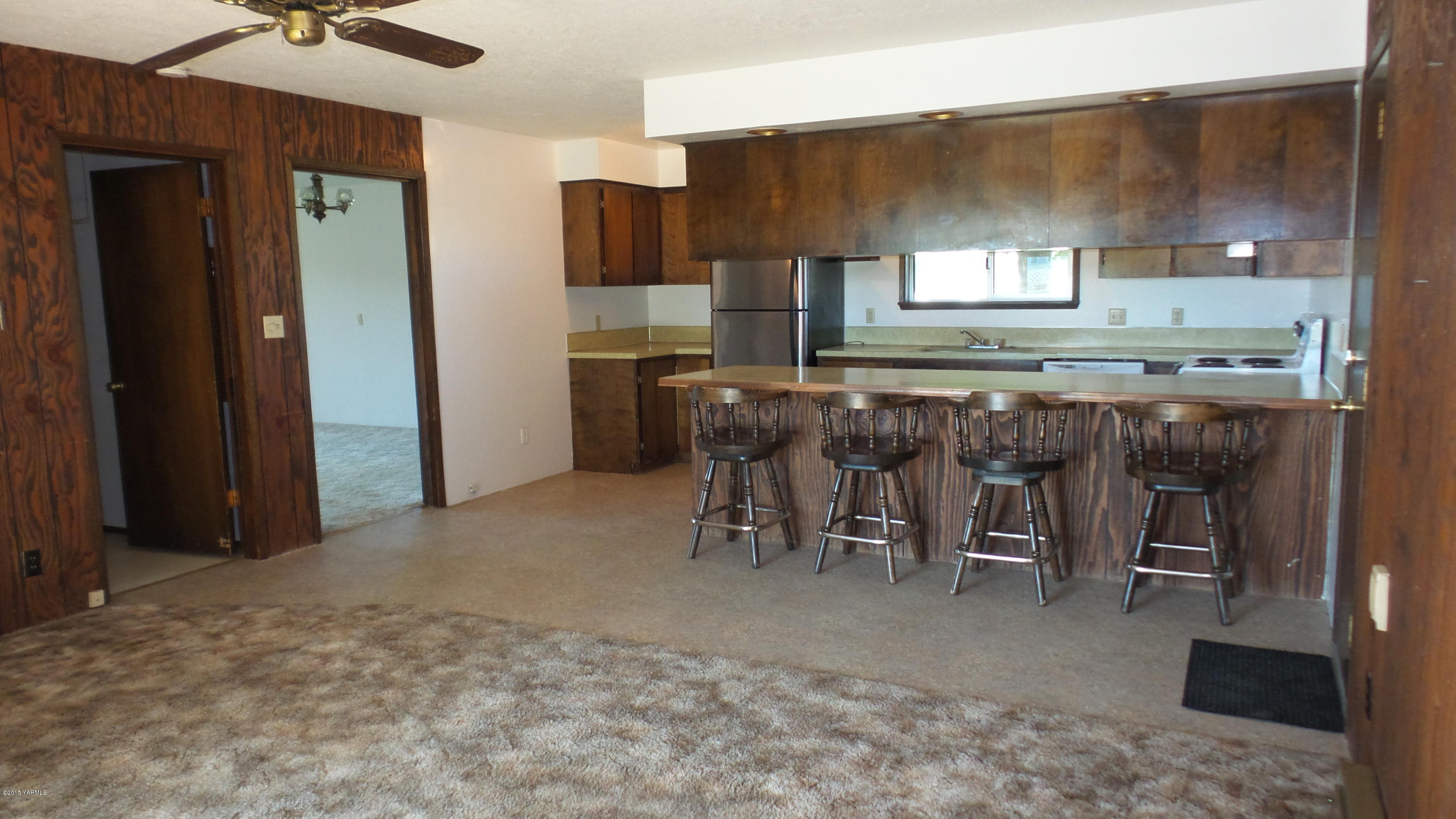 71 West Canyon Road Yakima, WA 98908 - Photo 8 of 19 a kitchen with lots of wooden cabinets appliances and furniture