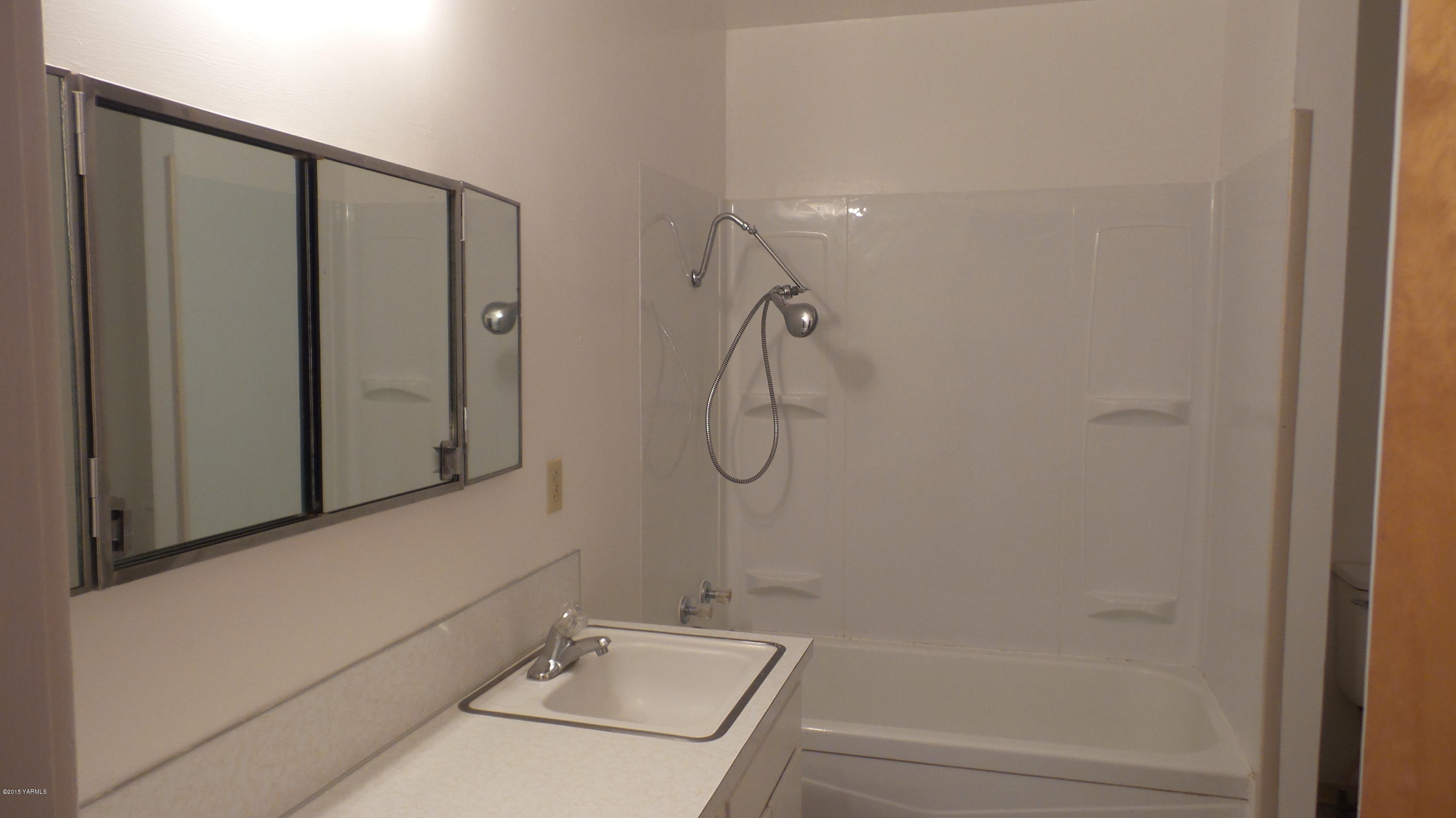 71 West Canyon Road Yakima, WA 98908 - Photo 10 of 19 a bathroom with a granite countertop sink a toilet and shower