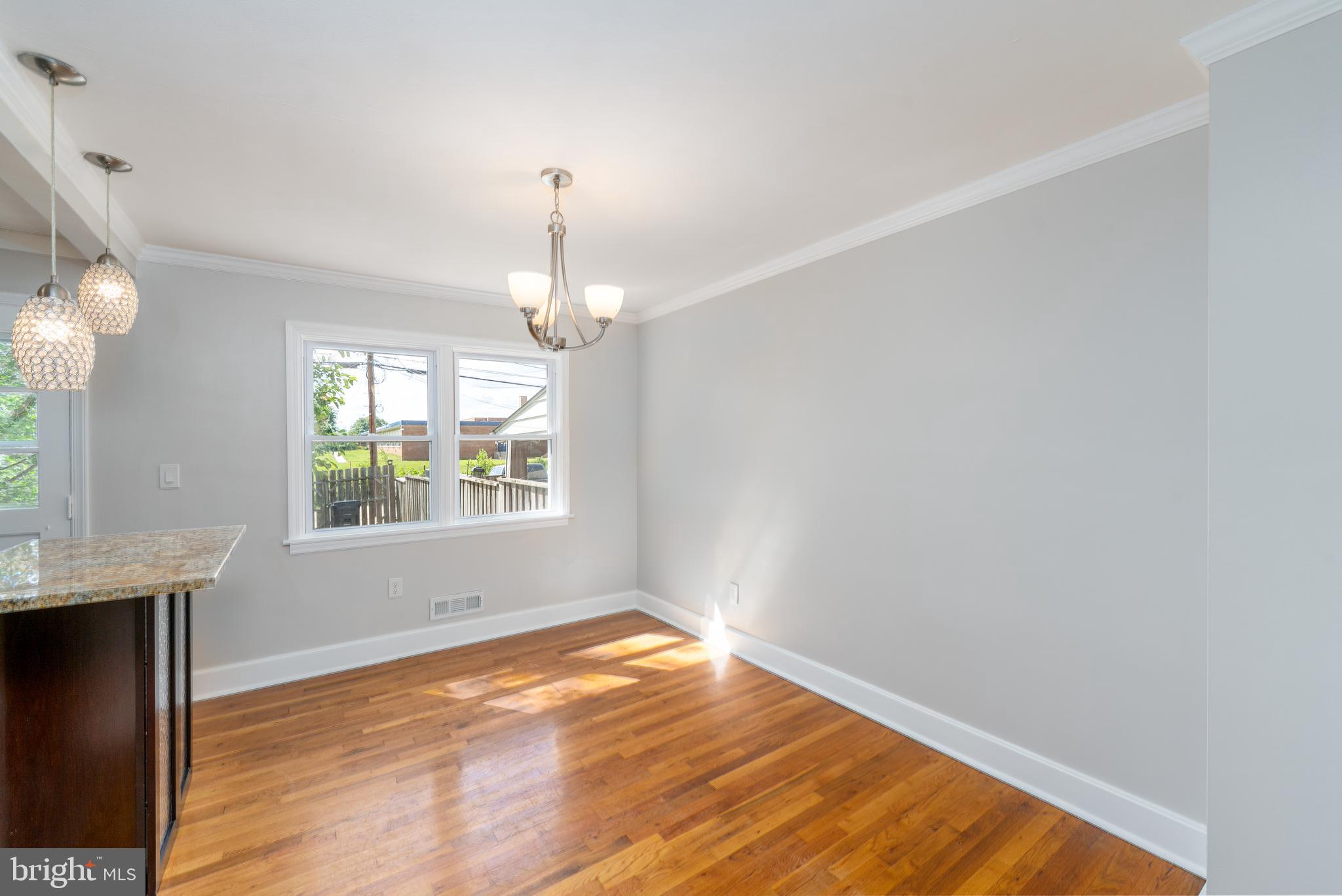 1738 Stokesley Road Baltimore, MD 21222 - Photo 16 of 34 a view of an empty room with wooden floor and a window