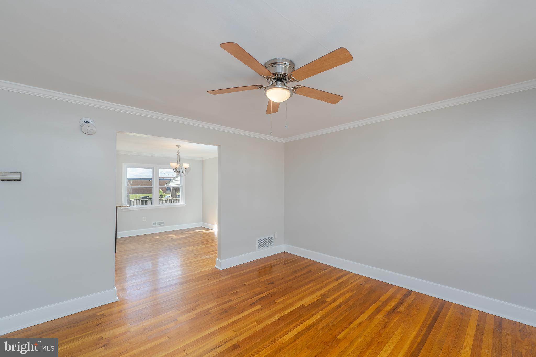 1738 Stokesley Road Baltimore, MD 21222 - Photo 18 of 34 an empty room with wooden floor and windows