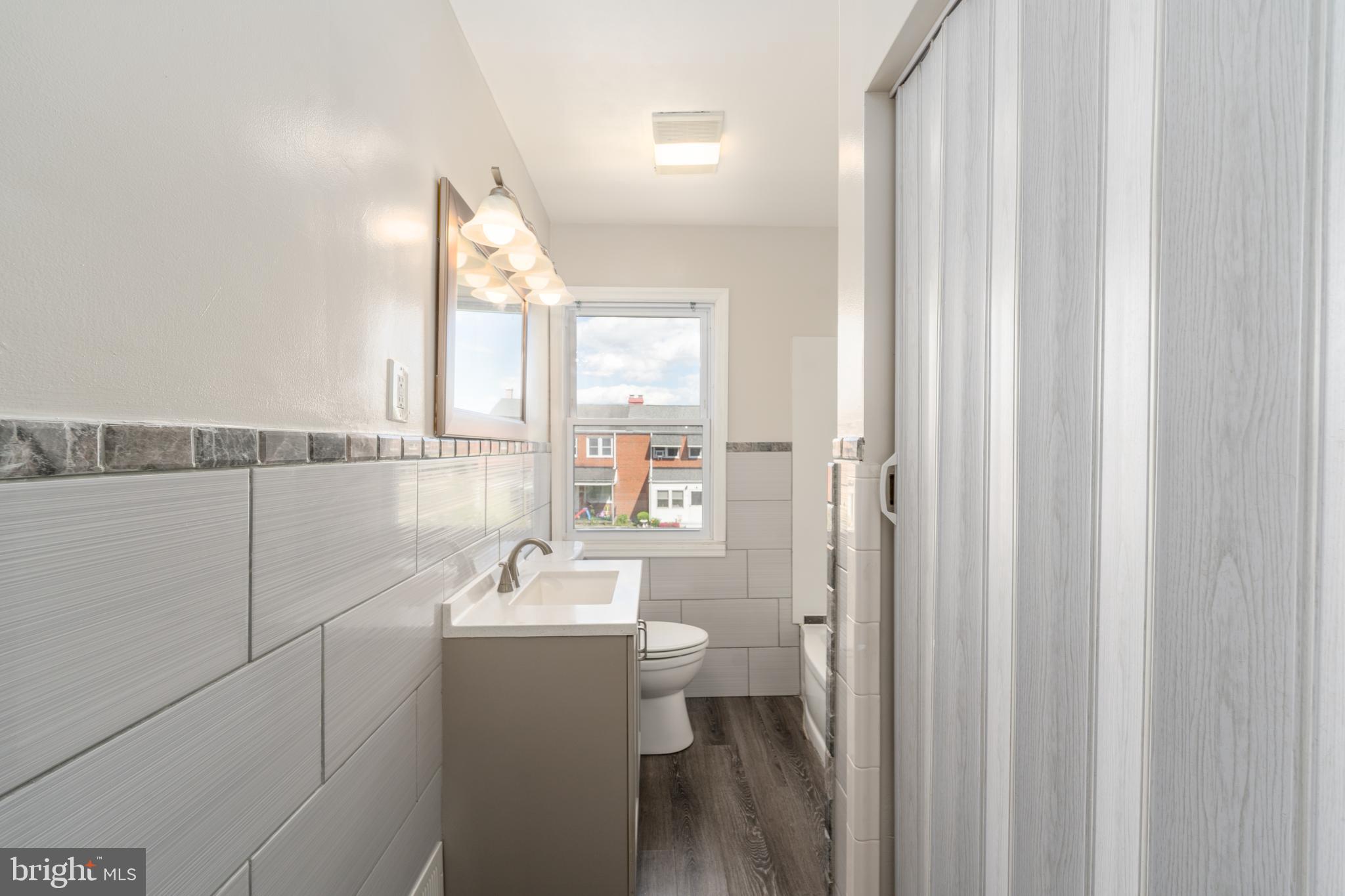 1738 Stokesley Road Baltimore, MD 21222 - Photo 20 of 34 a bathroom with a sink a toilet and shower